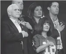  ?? MICHAEL CONROY/THE ASSOCIATED PRESS ?? Vice-President Mike Pence and his wife Karen stand during the playing of the U.S. national anthem before Sunday’s NFL game in Indianapol­is. Pence left over an anthem protest.