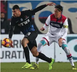  ??  ?? Atalanta's Andrea Petagna, left, and Crotone's Claiton Dos Santos Machado