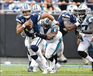  ?? PHOTOS BY GRANT HALVERSON / GETTY IMAGES ?? Panthers defensive lineman Kawann Short sacks Cowboys quarterbac­k Dak Prescott. Carolina’s aggressive rush dropped Prescott six times in Sunday’s game while holding Dallas to 232 yards (60 in the first half).