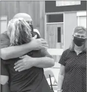  ??  ?? Above, Jeff Shea hugs EMT Kacey Woodliff-Finney at the City Council meeting Sept. 22. Woodliff-Finney was one of the first responders on the scene when Julie Griebel, right, called 911 on June 14.