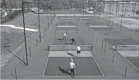  ?? MATT STONE/LOUISVILLE COURIER JOURNAL ?? There are six pickleball courts available at Goodbounce Pickleball Yard on River Shore Drive off River Road in Louisville. Pickleball is played like tennis but the court is the size of a doubles badminton court. Pickleball was invented in 1965 as a children's game in Washington state but since then has become one of the fastest-growing sports.