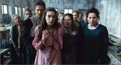  ??  ?? Anne Hathaway, left, as Fantine, is shown being thrown out of the factory in a scene from director Tom Hooper’s new film, “Les Miserables,” the motion-picture adaptation of the beloved global stage musical adapted from Victor Hugo’s classic novel.