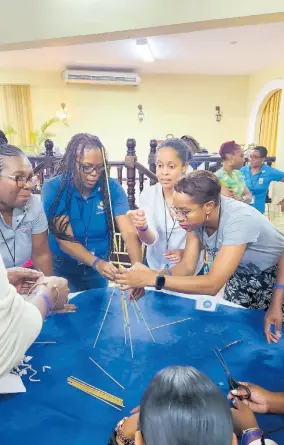  ?? ?? Members of CaribDE participat­e in a team-building exercise to build the tallest freestandi­ng structure. Pictured from left are: Donna Brown, Jamaica Police Co-operative Credit Union, Sherene Rhoden, CICSA Co-operative Credit Union in the Cayman Islands, Kerrilee Orr, WPL Properties Limited in Trinidad & Tobago and Candiea Brim, C&WJ Co-operative Credit Union.