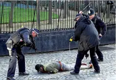  ?? — Reuters photo ?? Armed police taser a man inside the grounds of the Houses of Parliament in London.