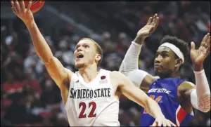  ?? Gregory Bull The Associated Press ?? San Diego State guard Malachi Flynn, left, a transfer from Washington State, is a strong candidate for Mountain West Player of the Year.