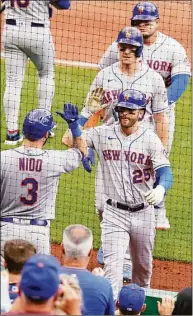  ?? Gene J. Puskar / Associated Press ?? New York Mets’ Tyler Naquin (25) returns to the dugout after hitting a three-run home run off Pittsburgh Pirates starting pitcher Bryse Wilson during the fourth inning of the first game of a doublehead­er in Pittsburgh on Wednesday.