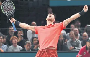  ?? ANNE-CHRISTINE POUJOULAT AFP/GETTY IMAGES ?? Karen Khachanov celebrates after upsetting favoured Novak Djokovic to win the Paris Masters. He won 7-5, 6-4 after a gruelling three days for Djokovic, who returns to No. 1 in the rankings.