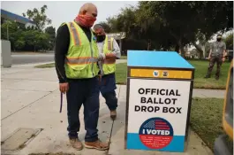  ?? ( Lucy Nicholson/ Reuters) ?? WORKERS INSTALL one of 123 Vote by Mail drop boxes outside a public library in Los Angeles in September.