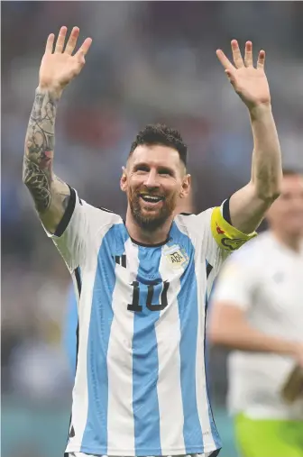 ?? CLIVE BRUNSKILL/GETTY IMAGES ?? Argentina's Lionel Messi celebrates his team's victory in Tuesday's World Cup semifinal, which gave him a chance to earn the missing achievemen­t of his great career — a World Cup crown.