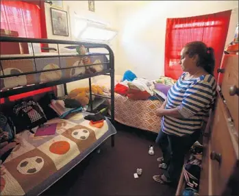  ?? Photograph­s by Genaro Molina
Los Angeles Times ?? JOSEFINA BARRALES looks at the bunk beds where her stepsons Luis, Juan and Alexander Fuentes once slept. The brothers, who loved sports, were found dead in the car they had apparently been living in.