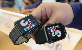  ?? RICHARD VOGEL/AP ?? An Apple store employee shows a customer the new Apple Watch Series 2 at the Apple Store at the Grove in Los Angeles.