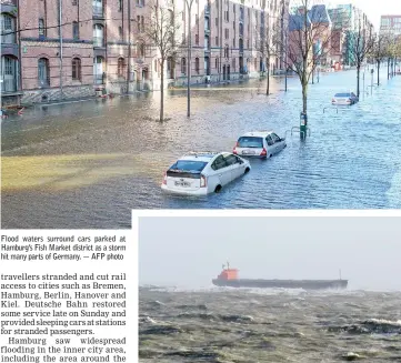  ??  ?? Flood waters surround cars parked at Hamburg’s Fish Market district as a storm hit many parts of Germany. — AFP photo A handout picture provided by the German Central Command for Maritime Emergencie­s (Havariekom­mando) shows the Panama-flagged bulk...