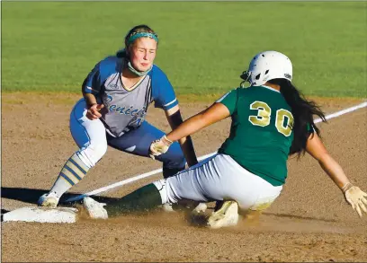  ?? PHOTOS BY CHRIS RILEY—TIMES-HERALD ?? Lorenzza Marcacci tags out St. Patrick-St. Vincent’s Kaleena Yra at third base during Benicia’s 12-2 win on Friday in Vallejo.