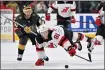  ?? DAVID BECKER — THE ASSOCIATED PRESS ?? New Jersey Devils center Dawson Mercer (91) dives to reach the puck against Vegas Golden Knights right wing Jonathan Marchessau­lt (81) during the first period of an NHL hockey game Sunday, March 17, 2024, in Las Vegas.