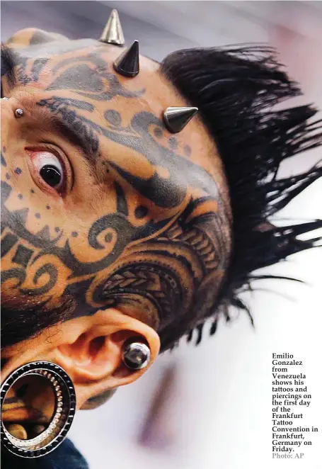  ??  ?? Emilio Gonzalez from Venezuela shows his tattoos and piercings on the first day of the Frankfurt Tattoo Convention in Frankfurt, Germany on Friday. Photo: AP