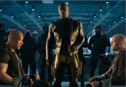  ??  ?? This image released by universal Pictures shows, foreground from left, dwayne Johnson, Idris Elba and Jason Statham in a scene from “Fast & Furious Presents: Hobbs & Shaw. UNIVerSAl PICtUreS VIA AP