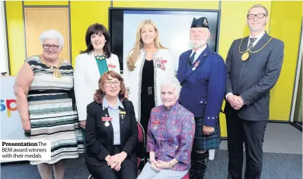  ??  ?? Presentati­onthe BEM award winners with their medals