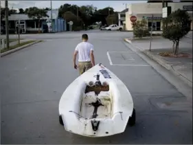  ??  ?? Emmett West pulls his boat from a nearby marina to secure it at his home ahead Hurricane Florence in Morehead City, N.C., on Tuesday. AP PHOTO/DAVID GOLDMAN