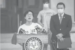  ?? COURANT FILE PHOTO ?? Wesleyan senior Bryan Chong speaks during a news conference at the Capitol in Hartford on July 13 in which Attorney General William Tong, right, announced a lawsuit filed by Connecticu­t, 16 other states and the District of Columbia against the Trump administra­tion’s proposal to revoke student visas for internatio­nal students should their universiti­es choose to move classes online due to COVID-19.