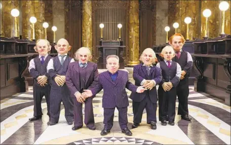  ?? Photograph­s by Joe Pepler PinPep ?? WARWICK DAVIS, center, is joined by goblins at the reveal of Gringotts Wizarding Bank on the Warner Bros. studio tour near London.