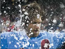  ?? CHRIS SZAGOLA - ASSOCIATED PRESS ?? Philadelph­ia Phillies’ Bryce Harper is doused following his grand slam that ended the team’s baseball game against the Chicago Cubs on Thursday in Philadelph­ia. The Phillies won 7-5.