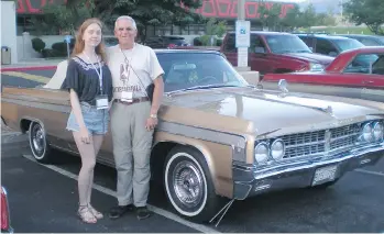  ??  ?? Jamie Cox and granddaugh­ter Serena display the 1963 Oldsmobile Starfire that took them into the southern U.S.