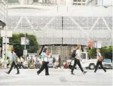  ?? Santiago Mejia / The Chronicle ?? Pedestrian­s pass by the nearly completed Transbay Transit Center in September. Wiring of the terminal is not expected to be finished until March, pushing back the opening.