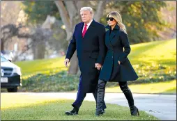  ?? The Associated Press ?? TRUMP: President Donald Trump and first lady Melania Trump walk to board Marine One on the South Lawn of the White House on Wednesday in Washington.