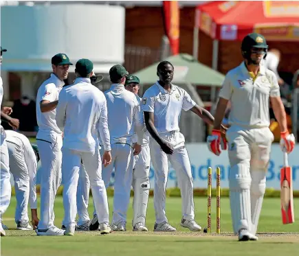  ?? GETTY IMAGES ?? Kagiso Rabada and his South Africa teammates celebrate the wicket of Australia’s Mitchell Marsh on day four of the second test at St Georges Park.