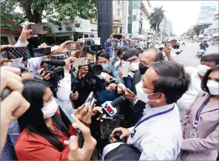  ?? HEAN RANGSEY ?? Journalist­s interview the lawyers of former CNRP leader Kem Sokha at the Phnom Penh Municipal Court on February 16.