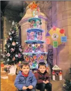  ??  ?? ■ Robin and Tommy with St Winefride’s Playgroup tree which won the Children’s organisati­ons category.