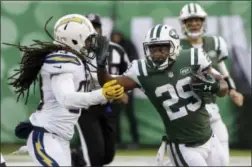  ?? SETH WENIG — THE ASSOCIATED PRESS ?? New York Jets running back Bilal Powell (29) fends off Los Angeles Chargers’ Tre Boston (33) during the second half of an NFL football game Sunday in East Rutherford, N.J.