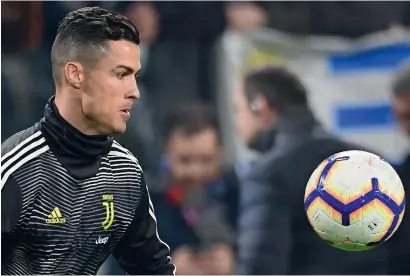  ?? AFP ?? Juventus superstar Cristiano Ronaldo eyes the ball during a training session in Turin ahead of the do-or-die clash with Atletico. —