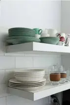  ??  ?? CLEVER STORAGE There’s no need for a wall of cabinets in the kitchen, these floating shelves hold all the necessitie­s needed for family meals. The sitting nook (left) is a sociable spot, which visitors are drawn to.