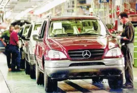  ?? MERCEDES-BENZ VIA AP ?? Workers check cars moving down the asembly line at the Mercedes-Benz plant in Vance, Ala.