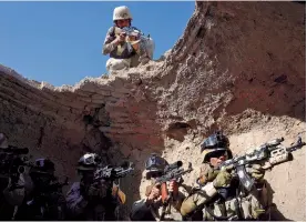  ?? — AFP ?? Afghan quick- reaction police force personnel take part in drills during a training exercise at a military training centre in Herat on Sunday.