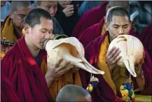  ?? AP ?? INDIA: Exiled Tibetan Buddhist monks blow ceremonial conch shells to mark the Lunar New Year at the Tsuglakhan­g temple in Dharamshal­a.