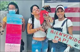  ?? Rancho Coastal Humane Society ?? YOHAMA, center, who came to the U.S. from Cuba seeking political asylum, and her chihuahua/miniature pinscher mix, Papi, were reunited in Tampa, Fla.