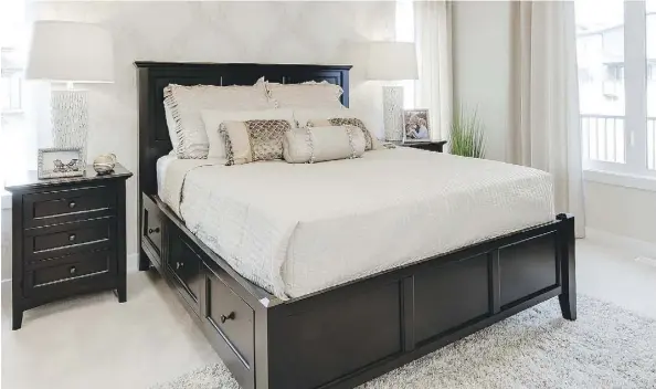  ?? PHOTOS: TREVOR BOLLER/BOLLER MEDIA PRODUCTION­S ?? A cream-coloured master bedroom uses contempora­ry large-patterned wallpaper and luxurious fabrics for a clean look. At right, a chrome lighting package and expandable frosted glass tabletop offer practical glamour.