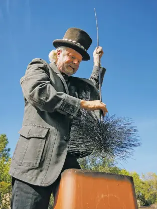  ?? MATT DAHLSEID/THE NEW MEXICAN ?? Richard Rice, owner of Casey’s Top Hat Chimney Sweeps, sweeps a chimney with his brush Thursday afternoon in Santa Fe. Rice says the company has swept and inspected more than 40,000 chimneys in the Santa Fe area in its 41 years of operation.