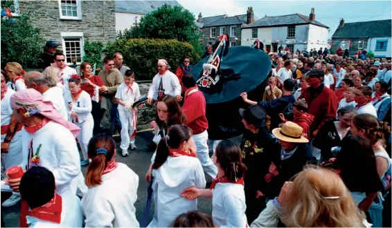  ?? GOUK/NEIL SUTHERLAND/ALAMY STOCK PHOTO ?? The ‘Obby ‘Oss procession in the streets of the Cornish town of Padstow on May Day.