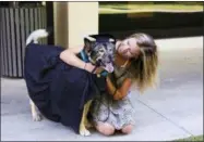  ?? ECKERD COLLEGE VIA AP ?? This 2017photo provided by Eckerd College shows a student and her pet at a pet graduation ceremony taking place at Eckerd College in St. Petersburg, Fla.