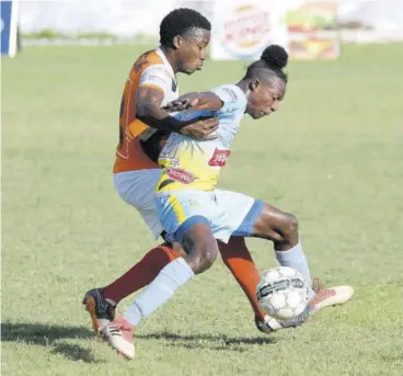  ?? (Photo: Joseph Wellington) ?? Waterhouse FC player Ricardo Thomas (right) protects the ball from Dunbeholde­n FC’S Nickoy Christian during last year’s abandoned Red Stripe Premier League season.