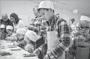  ?? NIKKI SULLIVAN/CAPE BRETON POST ?? Lucas Chen, 12, an exchange student from Beijing, China, decorates the chocolate bar he made at the chocolate making workshop at the Dobson Yacht Club in Westmount on Sunday. It was the first time Chen, who is in Cape Breton for three weeks, ever made...