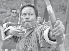  ?? — AFP photos by Arun Sankar ?? (Left and centre) Bhutanese archer aims at a target at the Changlimit­hang Archery Ground in Thimphu. (Right) an arrow maker heats a bamboo stick as he makes an arrow at the Bhutan Traditiona­l Archery shop.