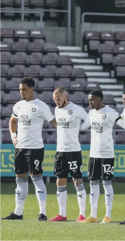  ??  ?? Posh players honour the late Tommy Robson with a minute’s silence.