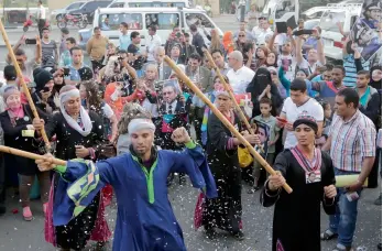  ?? — AP ?? Dancers in traditiona­l costumes perform as supporters of Egypt’s deposed longtime autocrat Hosni Mubarak celebrate his 87th birthday outside the Maadi Military Hospital, where he is hospitalis­ed, in Cairo on Monday.