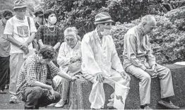  ?? CARL COURT/GETTY ?? At a remembranc­e event in Nagasaki Peace Park that was scaled down amid the coronaviru­s, people observe a minute of silence Sunday for victims of the atomic bombing..