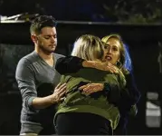  ?? MARK WALLHEISER / GETTY IMAGES ?? Matthew Rodin and Susan Turner comfort Melissa Hutchinson, who rendered aid to some of the victims of the mass shooting Friday night in Tallahasse­e, Florida.