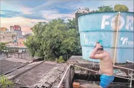  ??  ?? SOME WARAO live in tents while others are housed in downtown Manaus. They bathe out of buckets on rooftops and cook on hot plates hooked up to gas lines.